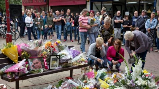 people-pay-their-respects-ahead-of-a-minute-s-silence-at-the