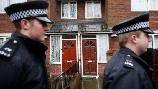 two-police-officers-walk-outside-a-flat-in-london_5617397.jpg
